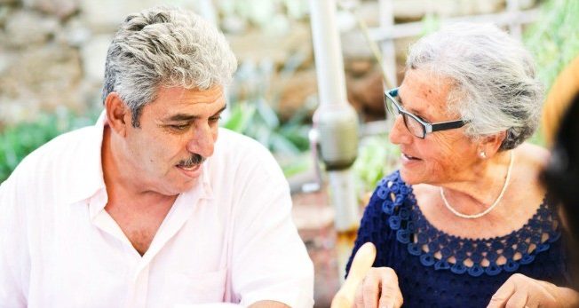 Two Cypriots talking and cooking