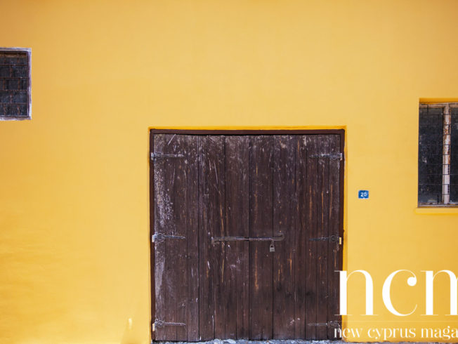 Yellow wall and wooden door